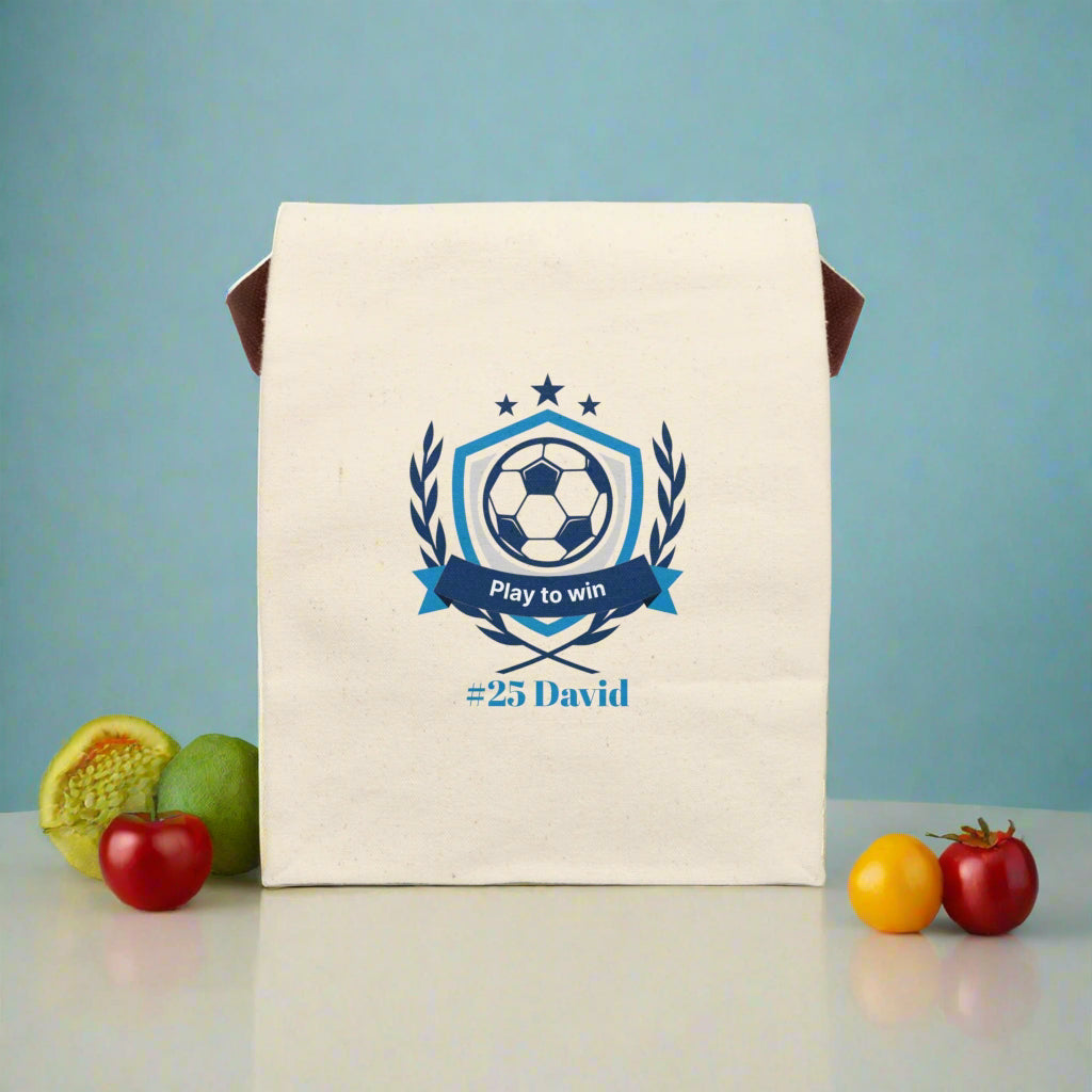 Beige towel with soccer-themed design and text on a white background